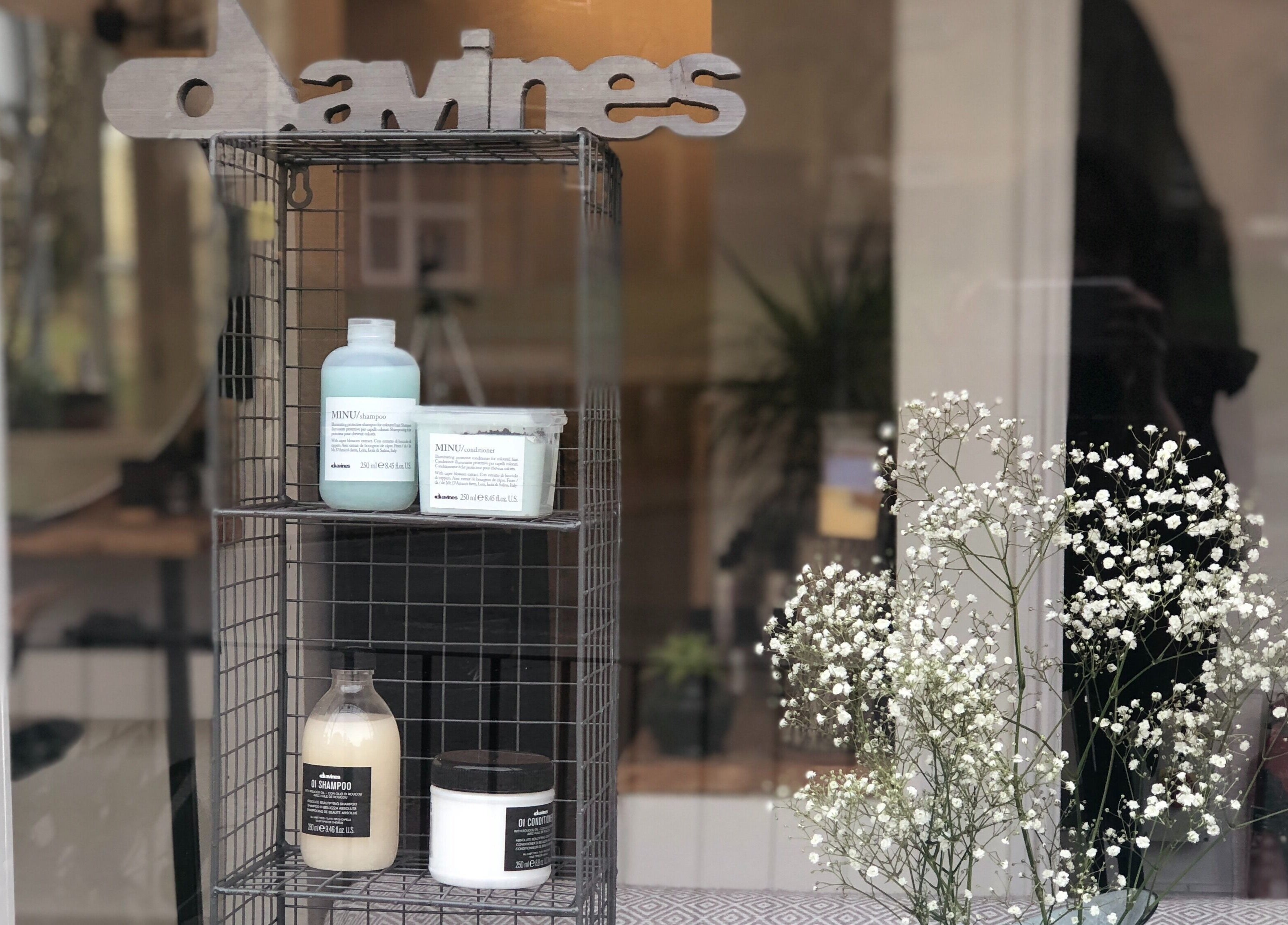 Elegant beauty products displayed at The Root in Harpenden, England, GB with delicate floral accents.