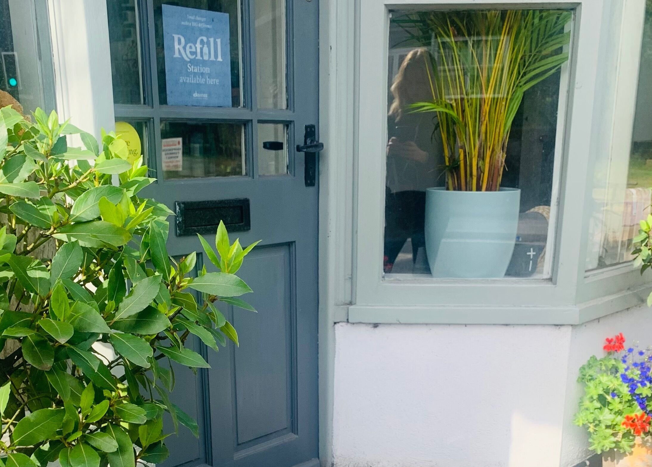 Charming entrance of The Root in Harpenden, England, GB with greenery and vibrant plants.