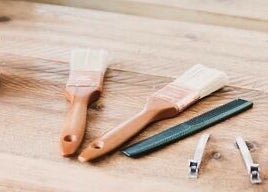 Beauty tools at The Root, Harpenden, England, GB. Includes brushes and hair clips on a wooden surface.