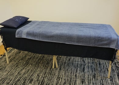 Massage table with blue towels at Zen Life Wellness, Linwood, Scotland, GB.