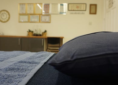 Cozy treatment room at Zen Life Wellness in Linwood, Scotland, GB with soft pillows and calming decor.