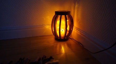 Ambient lamp casting a warm glow in Zen Life Wellness, Linwood, Scotland, GB.