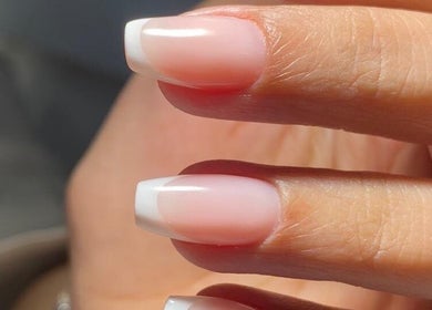 Elegant French manicure nails at Sisters Beauty Home Service, Riyadh, Riyadh Province, SA for a chic look.