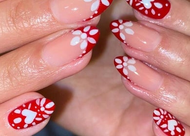 Red and white floral nail art by Sisters Beauty Home Service, Riyadh, Riyadh Province, SA.
