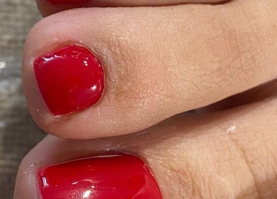 Close-up of red painted toenails at Sisters Beauty Home Service, Riyadh, Riyadh Province, SA.