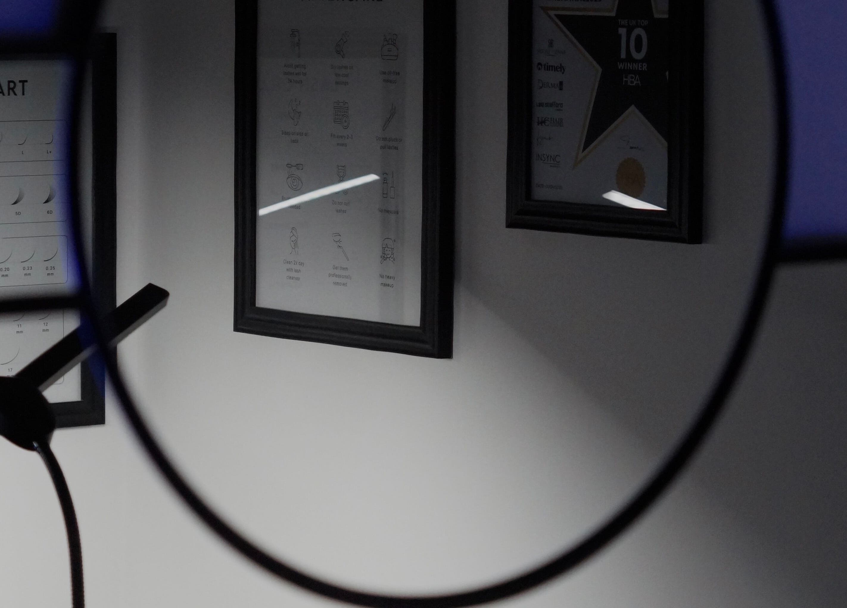 Close-up of framed lash charts and awards at BBS Beauty Gramm, Royal Leamington Spa, England, GB.