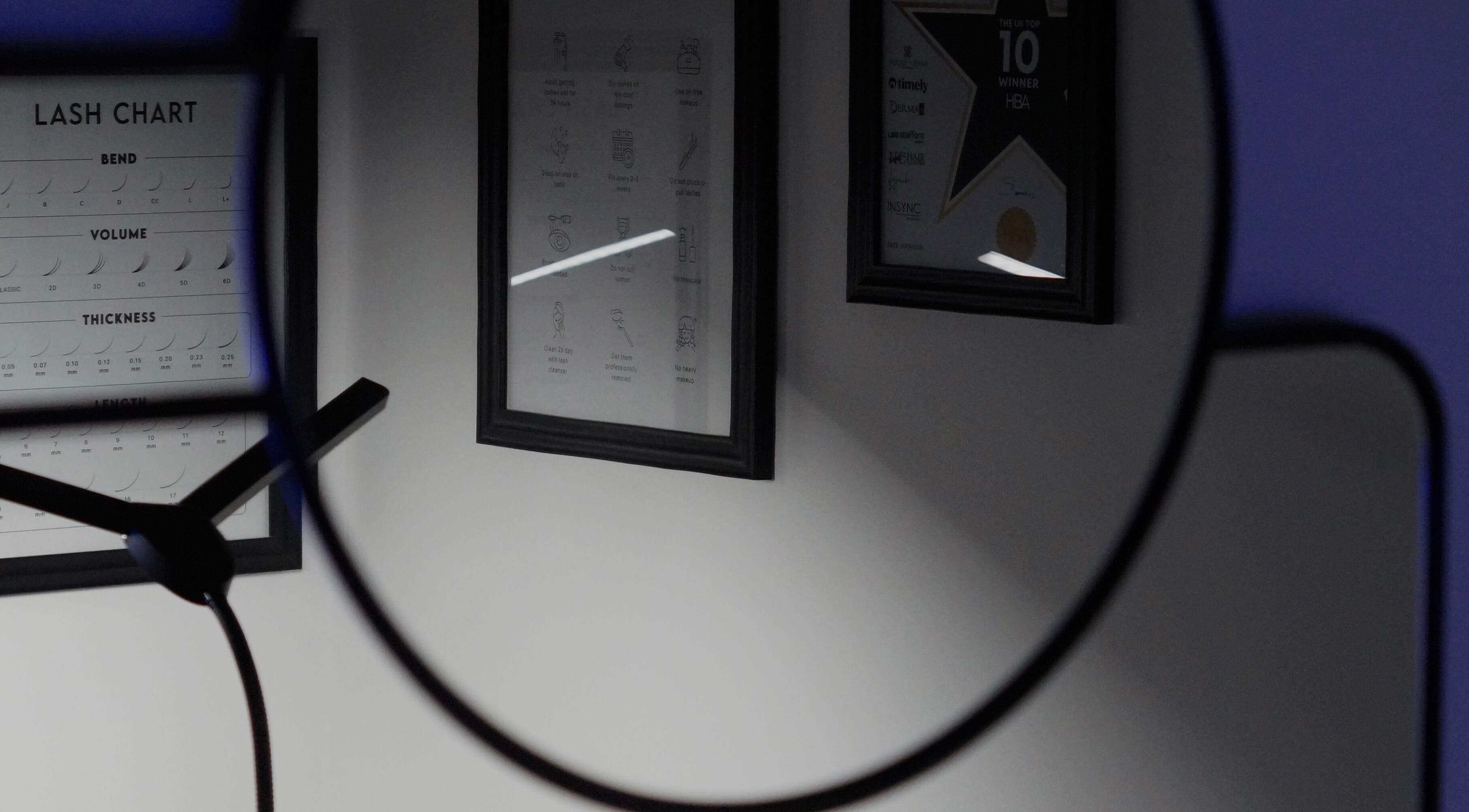 Close-up of framed lash charts and awards at BBS Beauty Gramm, Royal Leamington Spa, England, GB.