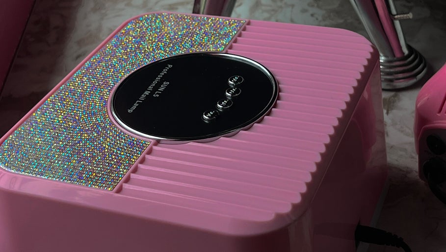 Glimmering pink nail dryer at Bling.ByBubbles in Gqeberha, Eastern Cape, ZA, enhancing salon experience.