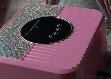 Glimmering pink nail dryer at Bling.ByBubbles in Gqeberha, Eastern Cape, ZA, enhancing salon experience.