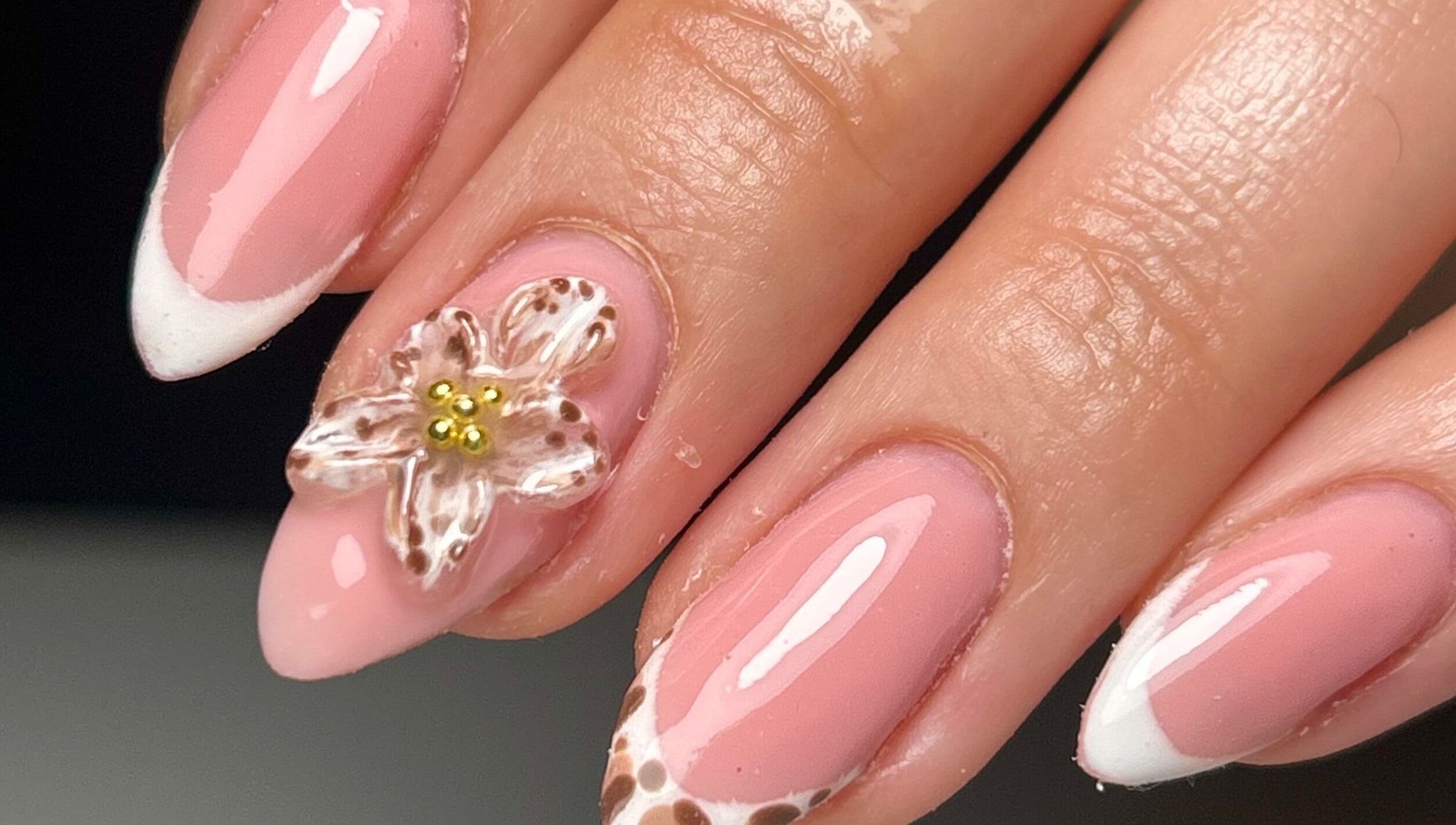 Elegant floral-themed nails at Sylvia Vanessa, Manchester, England, GB showcasing pink and white design.