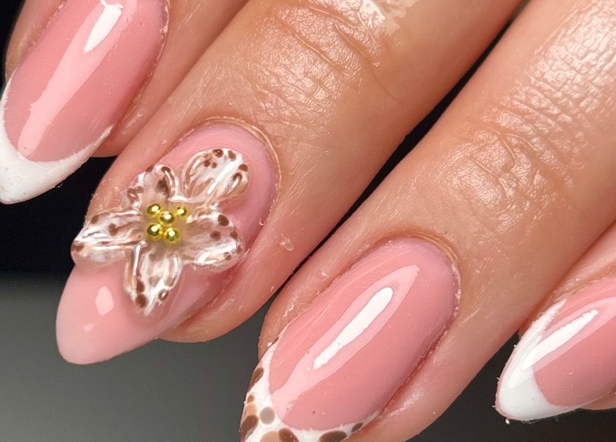 Elegant floral-themed nails at Sylvia Vanessa, Manchester, England, GB showcasing pink and white design.