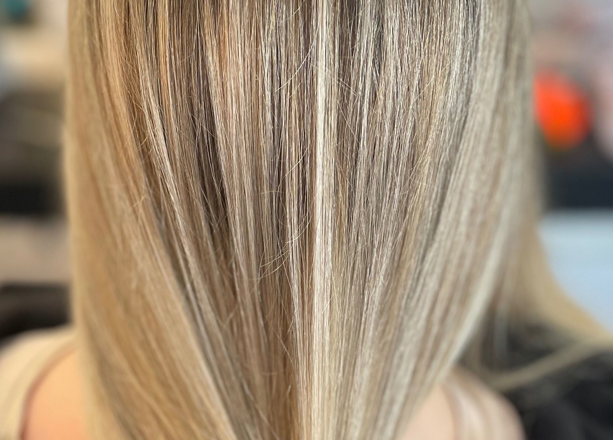 Close-up of sleek blonde hair at Kate Alexander Hair, Forfar, Scotland, GB showcasing fine highlights and smooth texture.