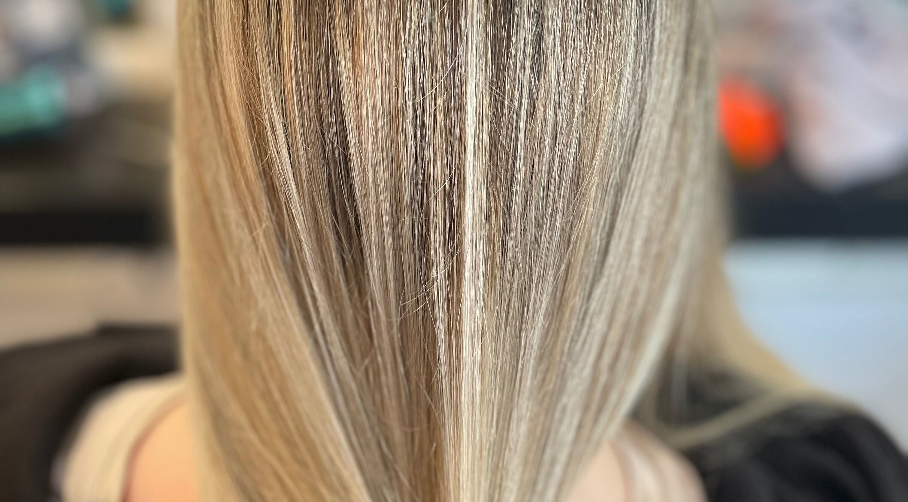 Close-up of sleek blonde hair at Kate Alexander Hair, Forfar, Scotland, GB showcasing fine highlights and smooth texture.