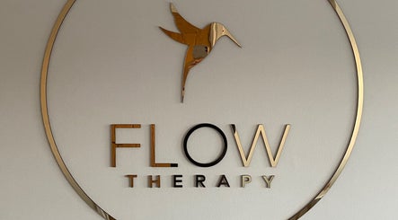 Flow Therapy sign featuring elegant gold bird logo in Seafield, Scotland, GB.