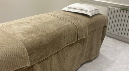 Massage table with plush linens at Flow Therapy in Seafield, Scotland, GB.
