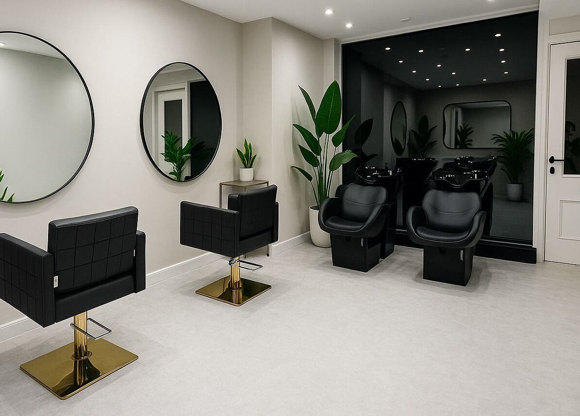 Stylish interior of HairNova Angel salon in London, England, GB with modern chairs and plants.
