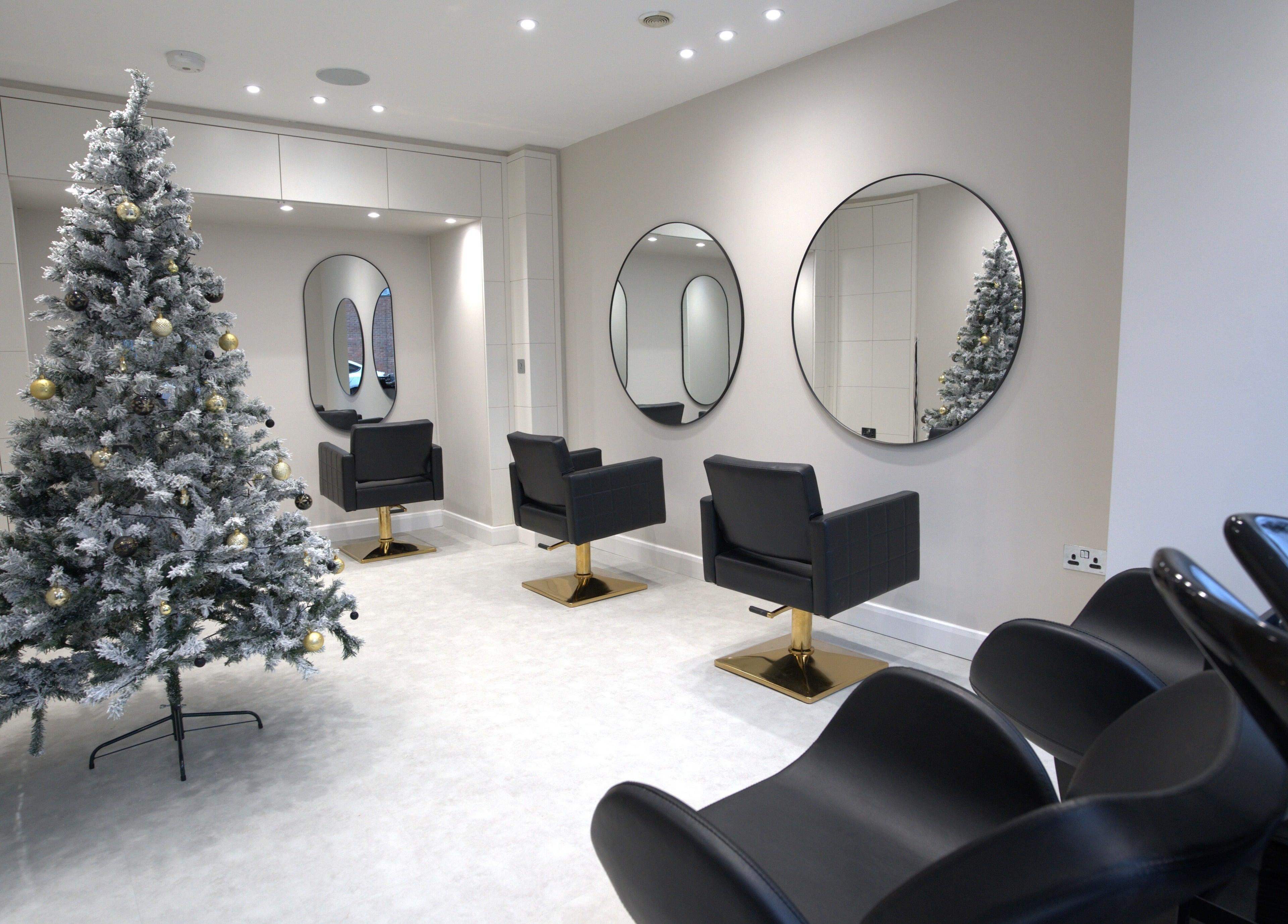 Elegant salon chairs and decor at HairNova Angel, London, England, GB, showcasing a festive atmosphere.