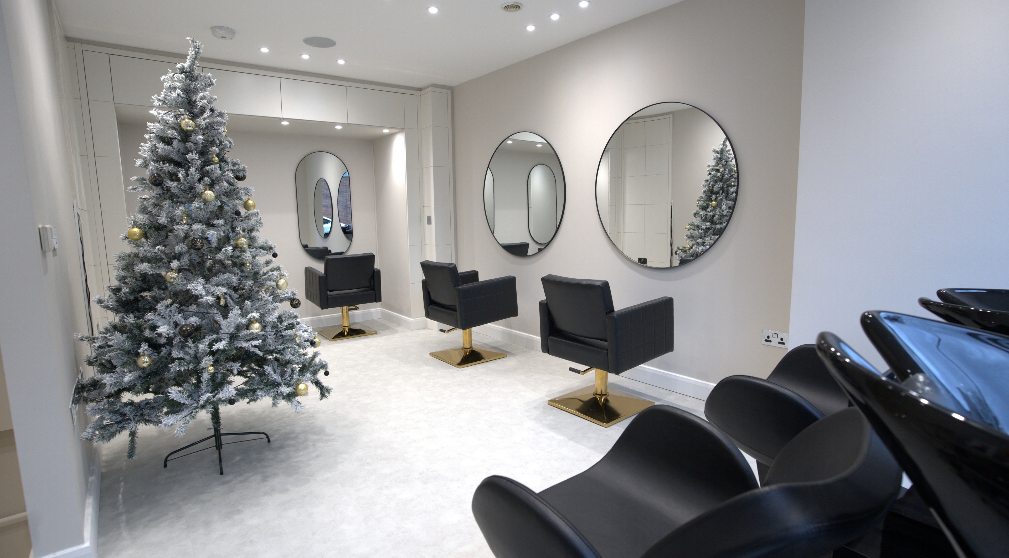 Elegant salon chairs and decor at HairNova Angel, London, England, GB, showcasing a festive atmosphere.
