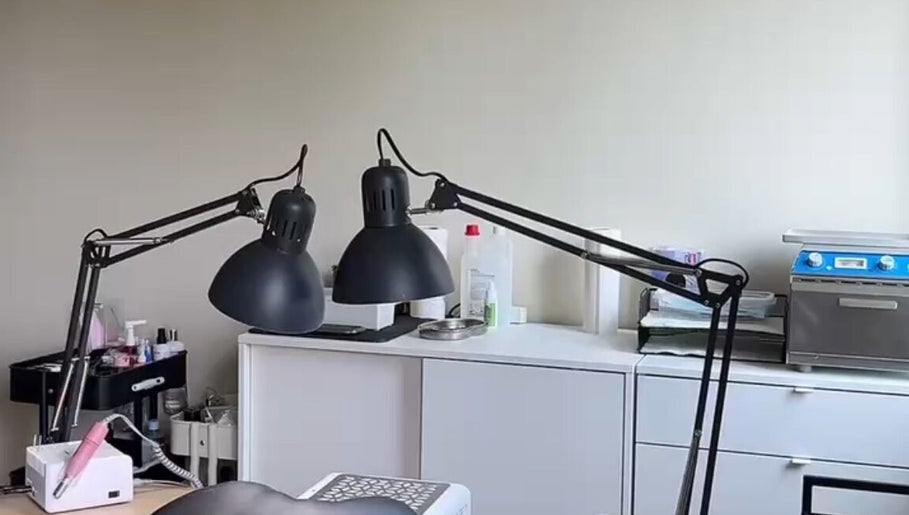 Cozy nail workspace at Lizeth Nailed It in Berlin, Berlin, DE, featuring stylish lamps and equipment.
