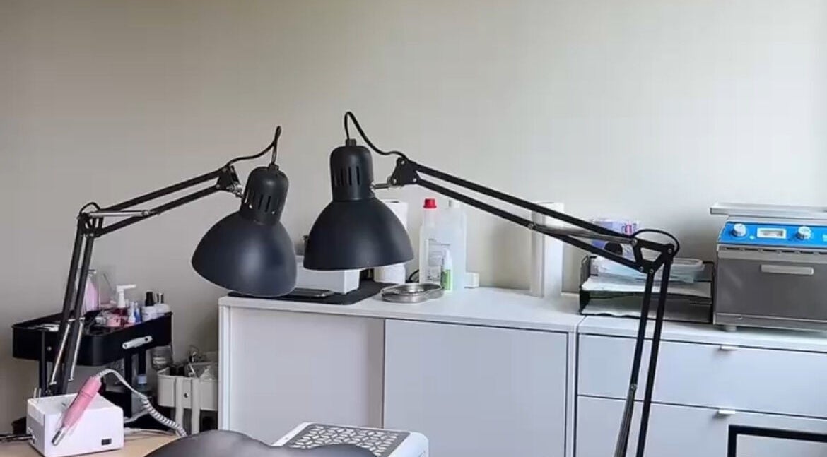 Cozy nail workspace at Lizeth Nailed It in Berlin, Berlin, DE, featuring stylish lamps and equipment.