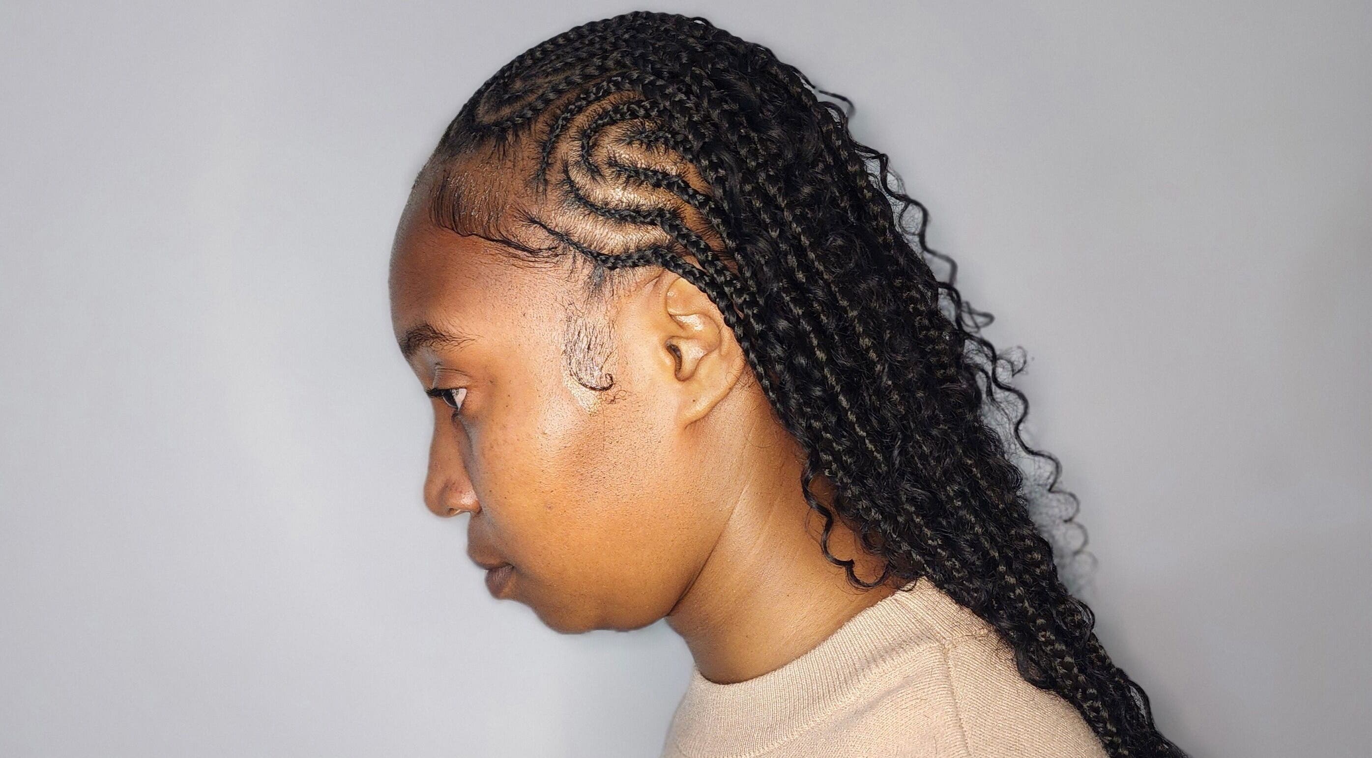 Side profile of intricate braids hairstyle at Buti Haven By Yhen, Montego Bay, St. James Parish, JM.