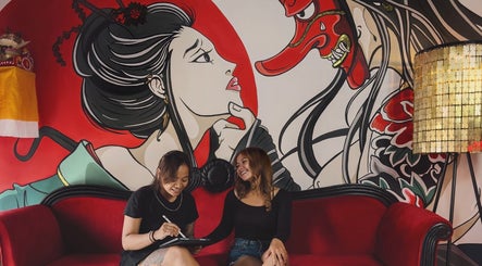 Guests enjoy the artistic lounge at RedDoors, Bali, Bali, ID, featuring vibrant mural art and cozy seating.