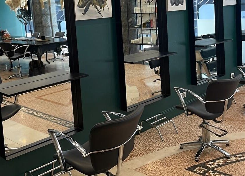 Modern salon chairs at Hair By Shlomi, Sydney, New South Wales, AU with sleek decor.