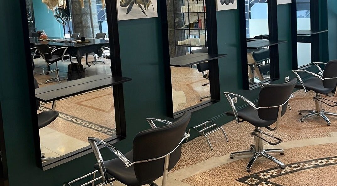 Modern salon chairs at Hair By Shlomi, Sydney, New South Wales, AU with sleek decor.