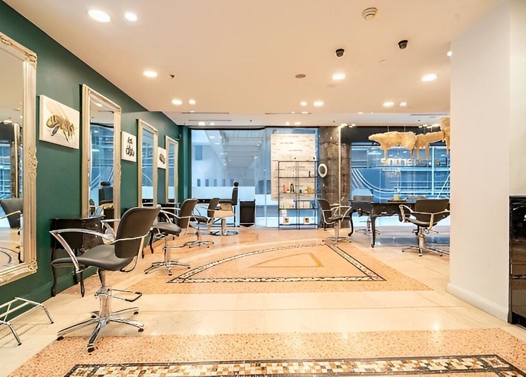Elegant salon interior at Hair By Shlomi, Sydney, New South Wales, AU with modern chairs and ornate mirrors.