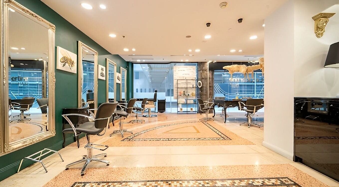 Elegant salon interior at Hair By Shlomi, Sydney, New South Wales, AU with modern chairs and ornate mirrors.