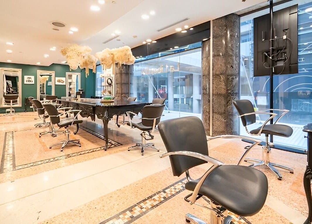 Modern salon chairs and mirrors at Hair By Shlomi in Sydney, New South Wales, AU, showcasing luxurious ambiance.