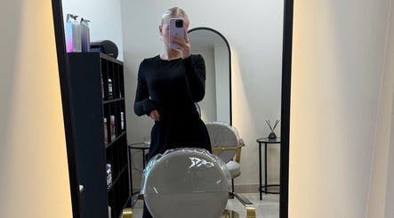 Modern hair studio at Hair by Sophie Ambrey in New Mills, England, GB, with elegant styling chair and mirror.