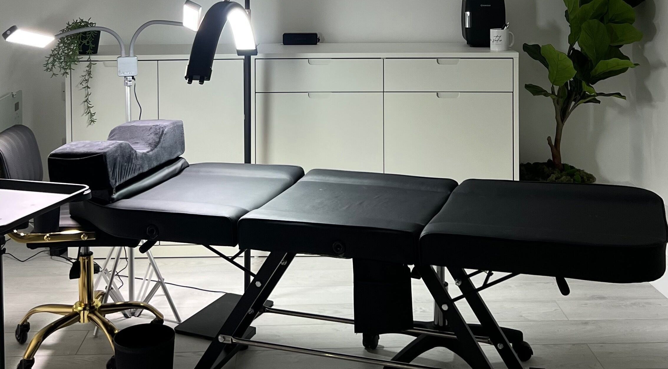 Calm treatment room at Mysa Studio, Orpington, England, GB, showcasing a professional massage table.