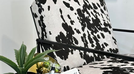 Stylish cowhide chair at Mysa Studio, Orpington, England, GB with succulent accent.