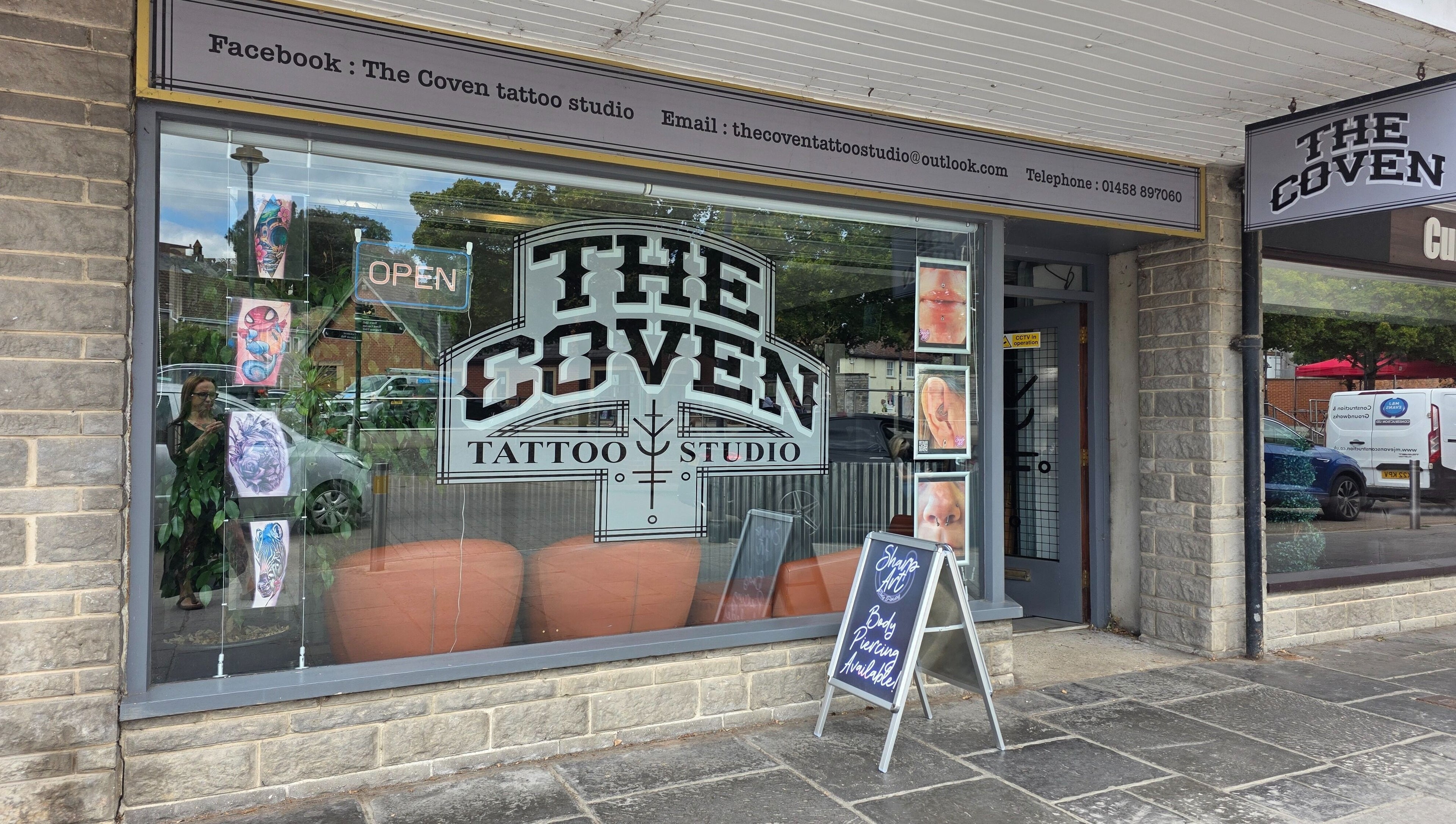 The Coven Tattoo Studio exterior showcasing art and signage for Sharp Art Body Piercing in Langport, England, GB.