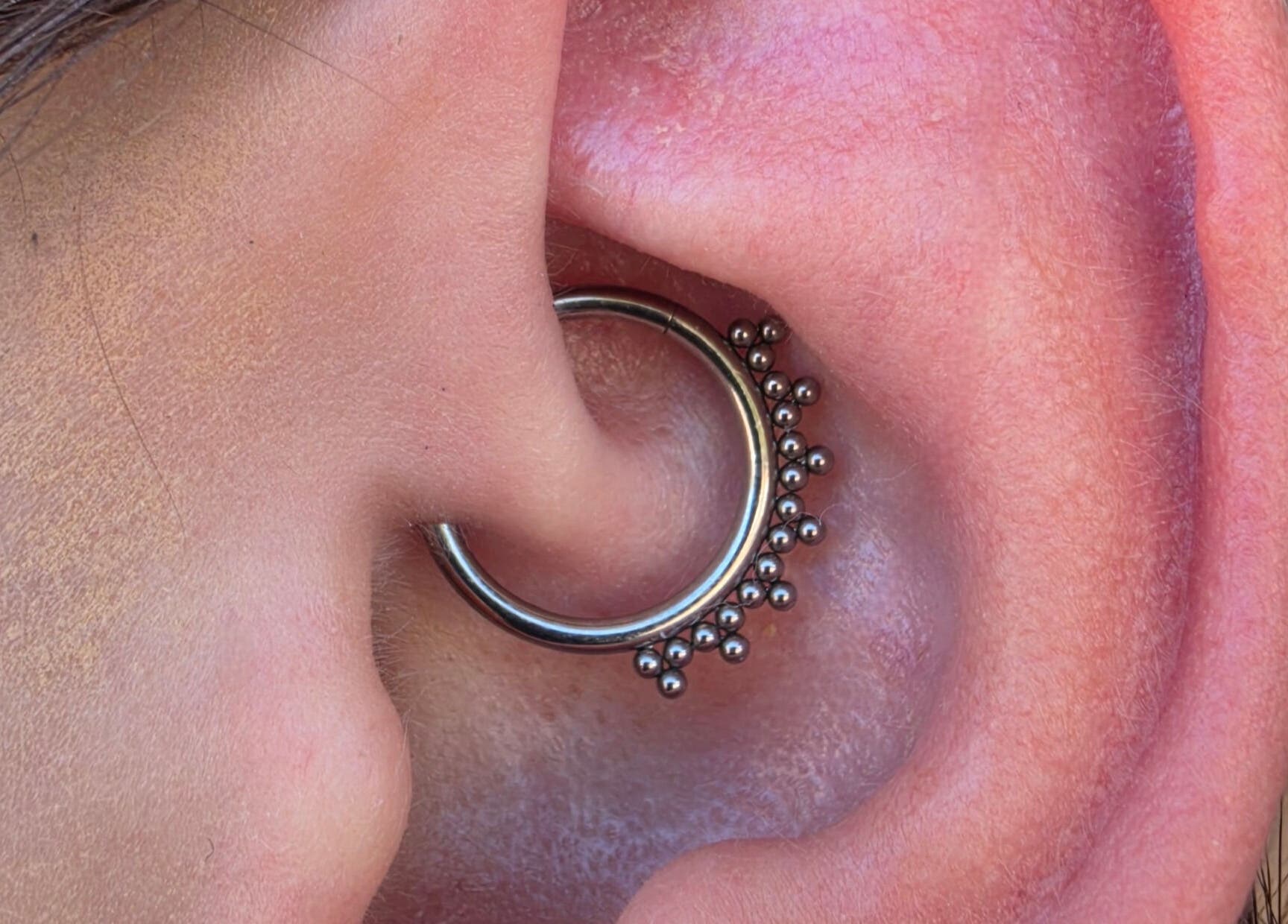 Stylish ear hoop piercing by Sharp Art Body Piercing in Langport, England, GB.