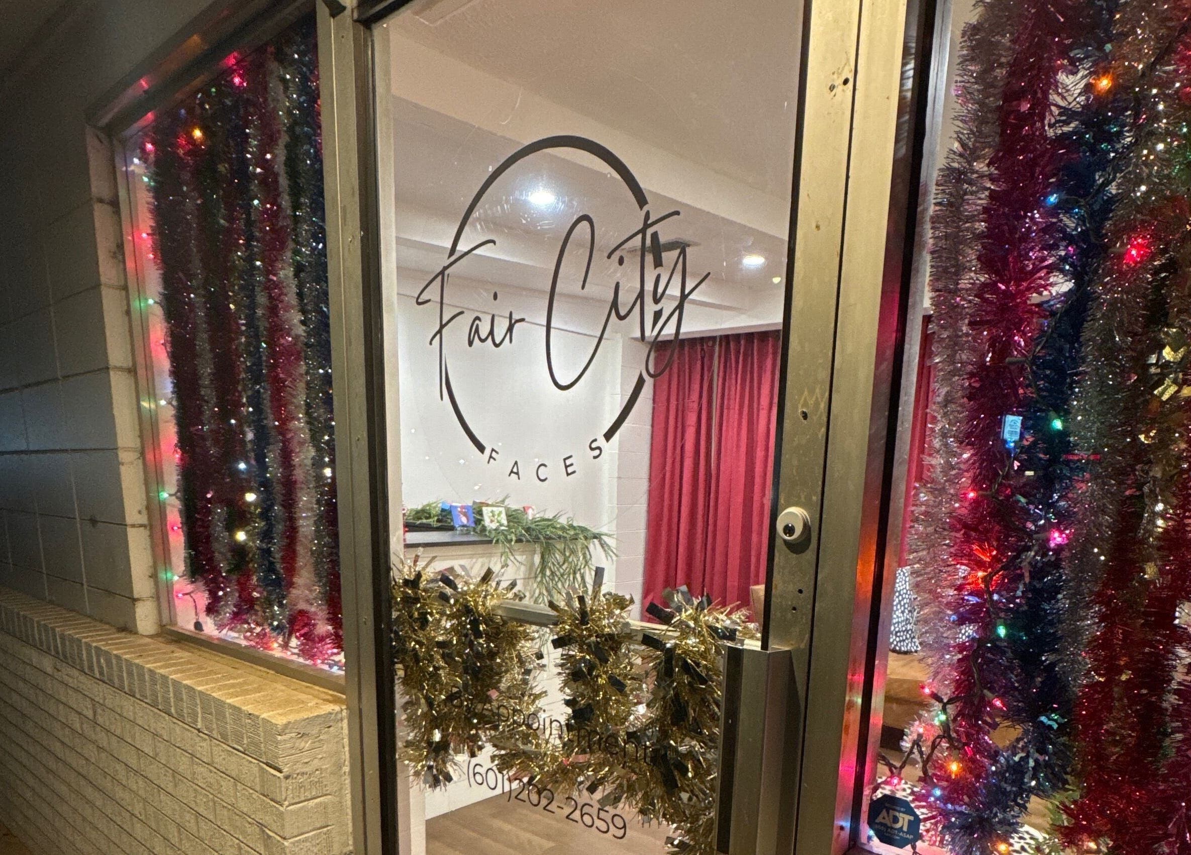 Festive door at Fair City Faces, Philadelphia, Mississippi, US decorated with colorful lights and tinsel.