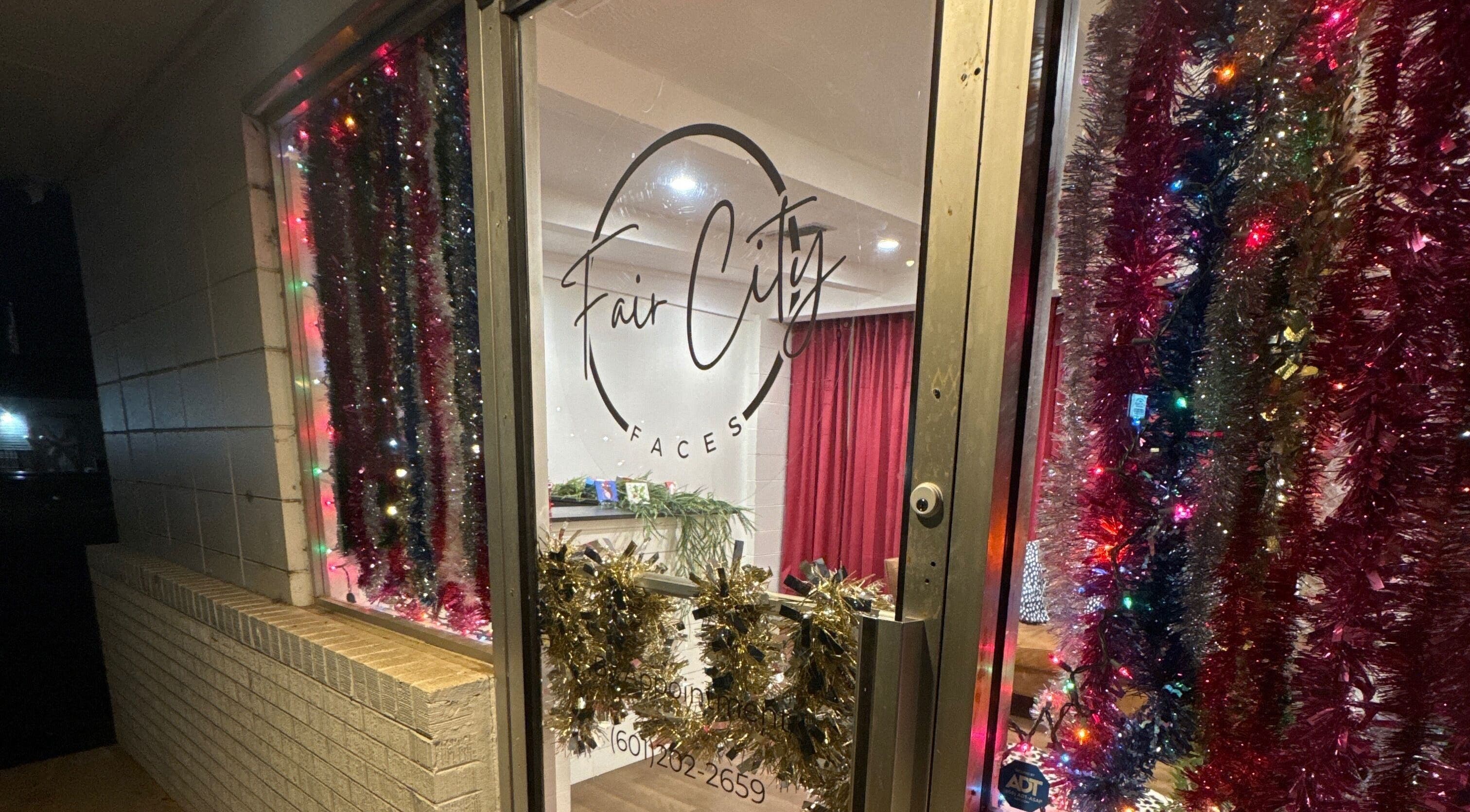 Festive door at Fair City Faces, Philadelphia, Mississippi, US decorated with colorful lights and tinsel.