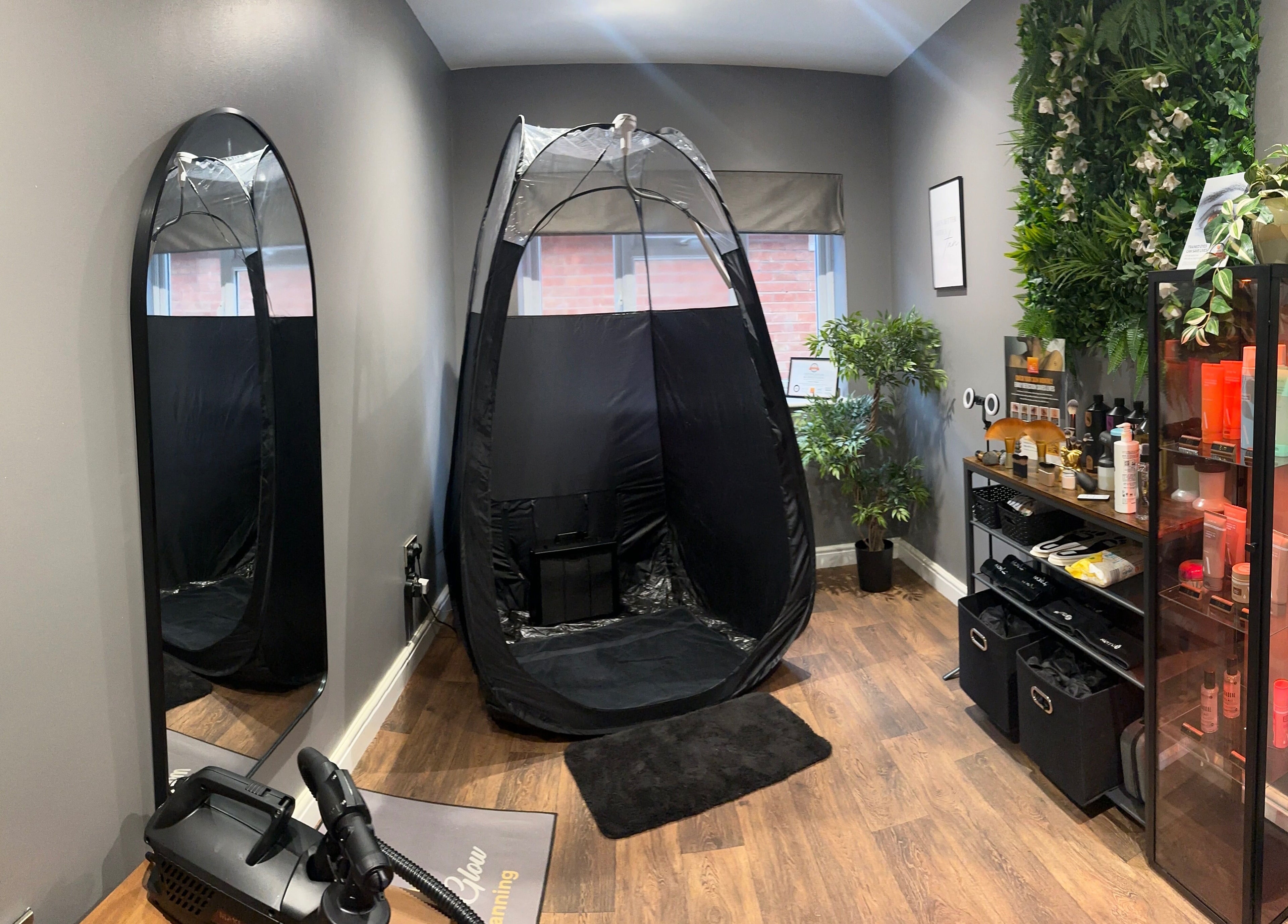 Modern tanning room with spray tent at Sunless Glow, Leicester, England, GB. Elegantly designed with plants and products.