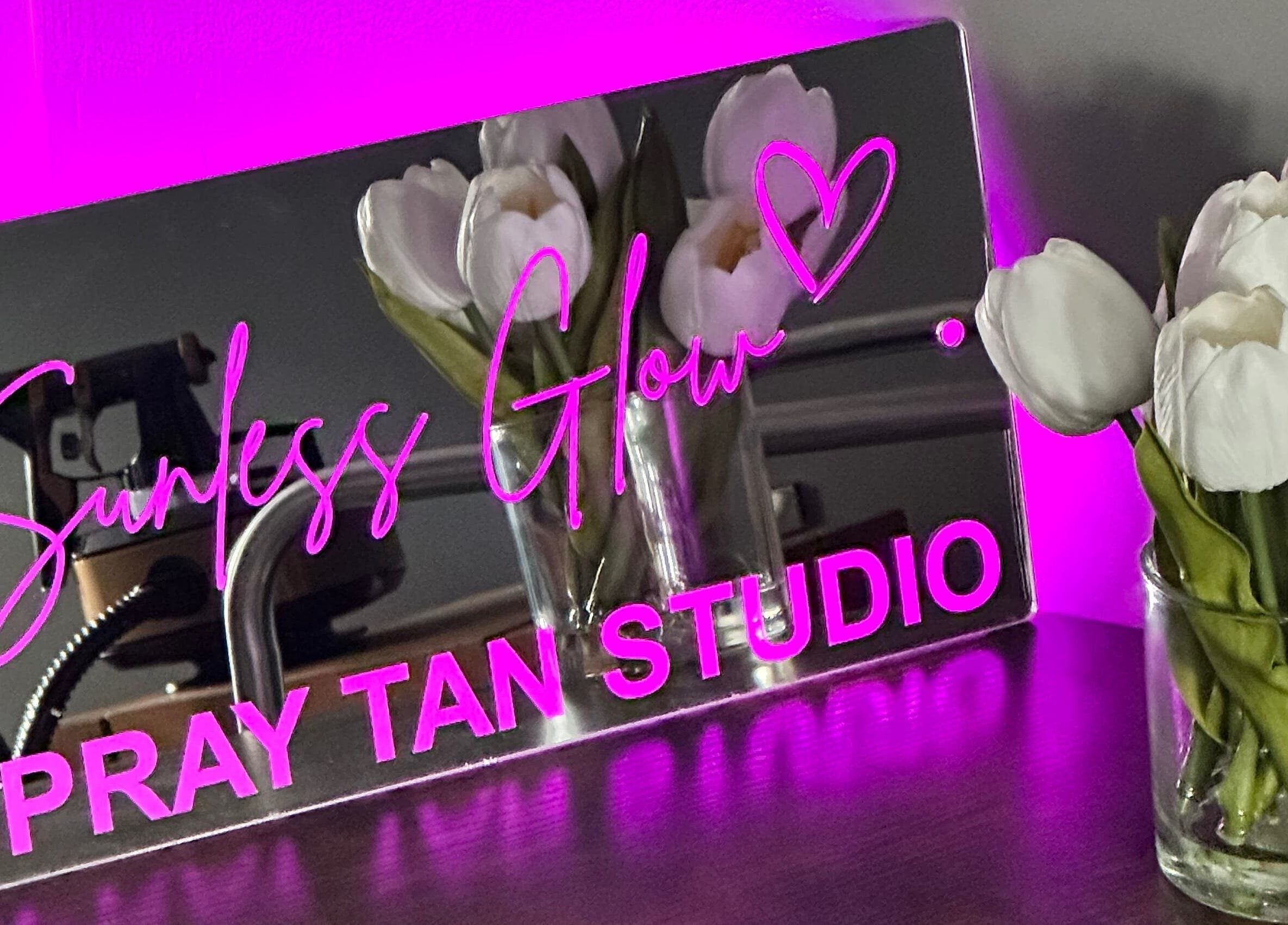 Sunless Glow spray tan studio sign with tulips, located in Leicester, England, GB.