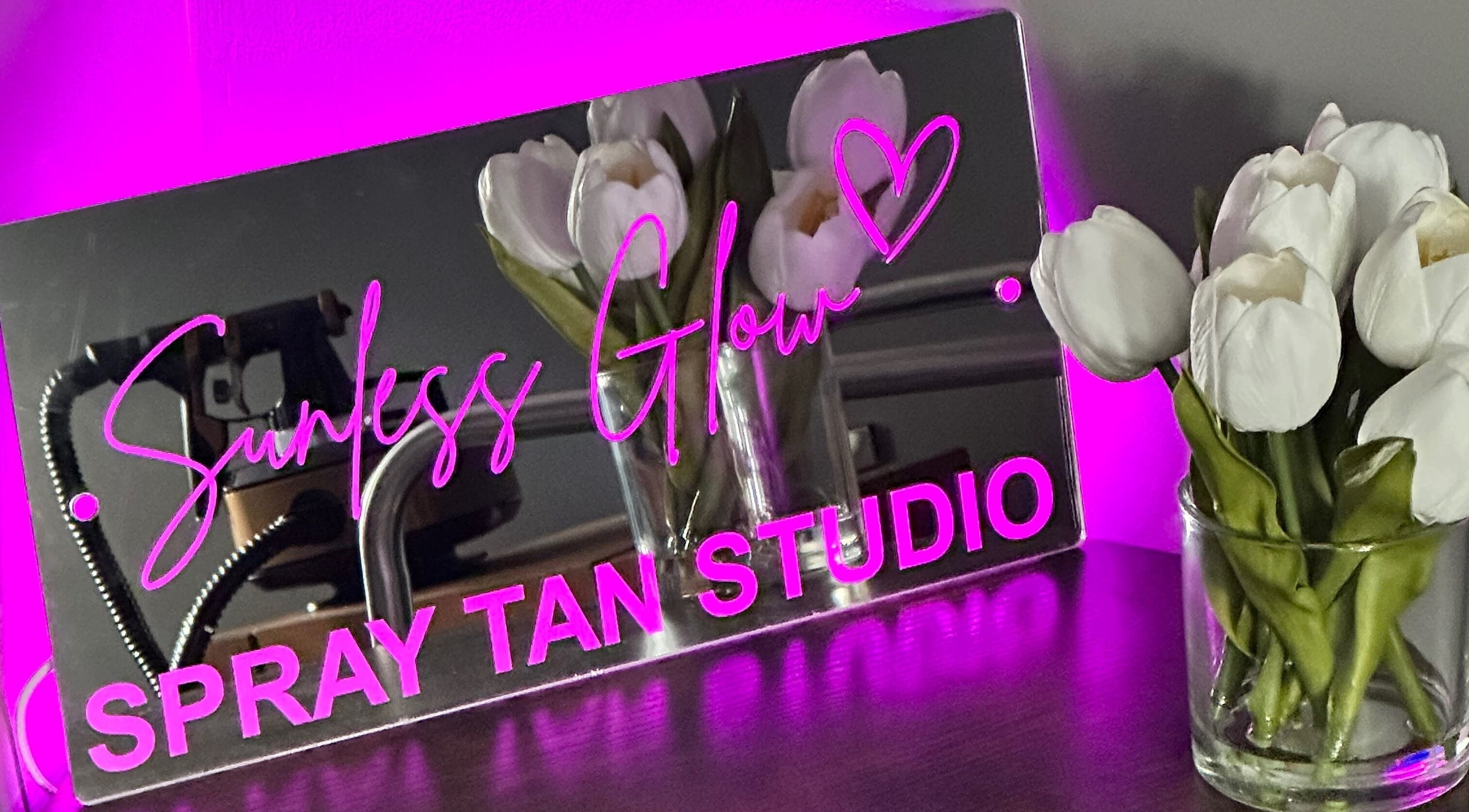 Sunless Glow spray tan studio sign with tulips, located in Leicester, England, GB.