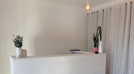 Elegant reception at Derma Aesthetics, Walvis Bay with modern decor and warm lighting.
