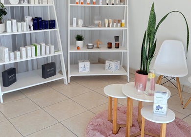 Product display and seating area at Derma Aesthetics, Walvis Bay, Erongo Region, NA showcasing beauty items.