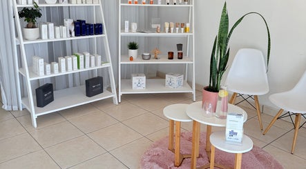 Product display and seating area at Derma Aesthetics, Walvis Bay, Erongo Region, NA showcasing beauty items.
