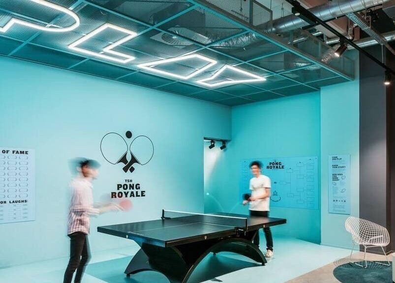 Modern ping pong lounge at Seba_Hair.cutz in Rotterdam, Zuid-holland, NL with neon 'PLAY' sign.