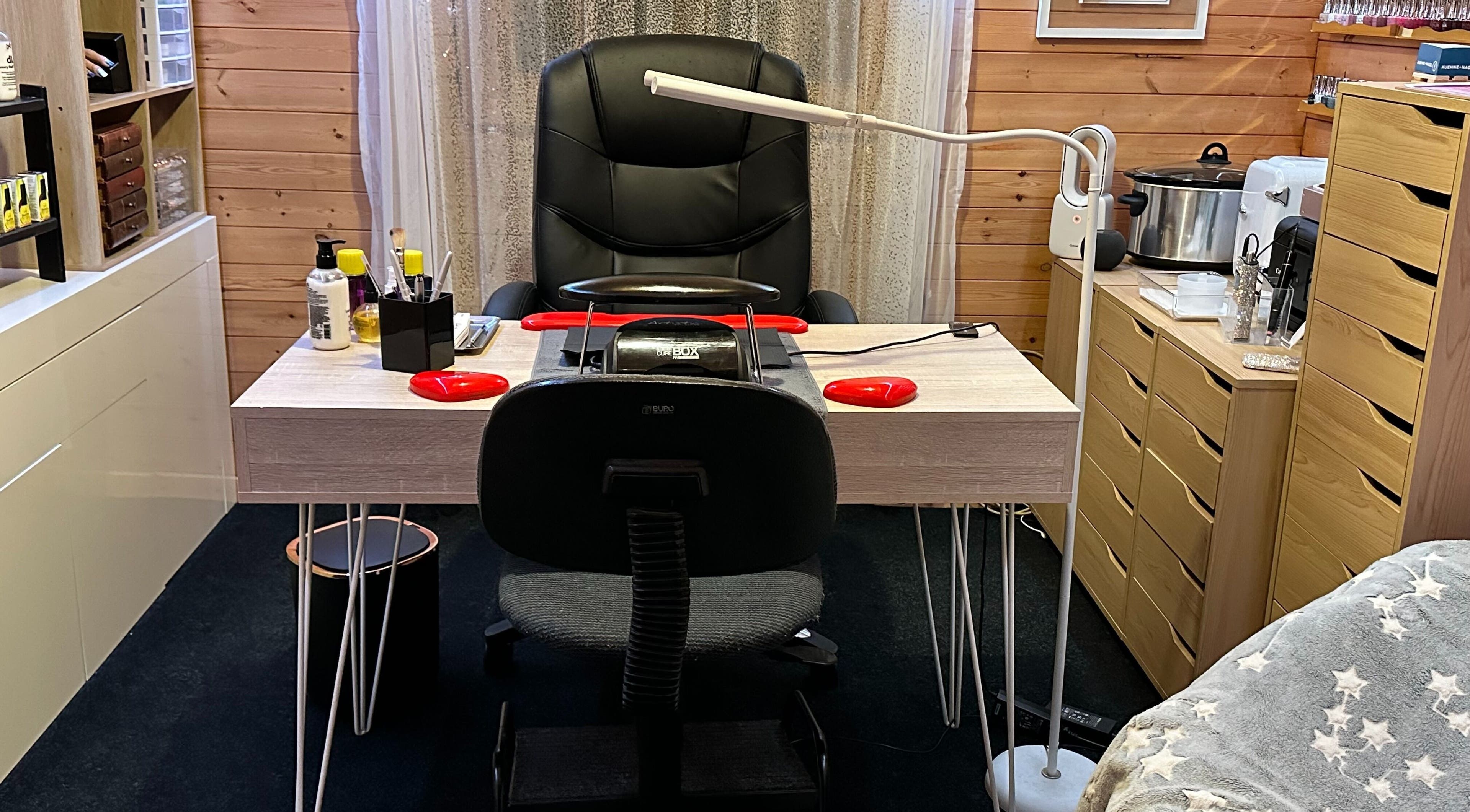 Nail station at The Dolls House Nail Studio, Renwick, Marlborough, NZ with tools and comfy chair.