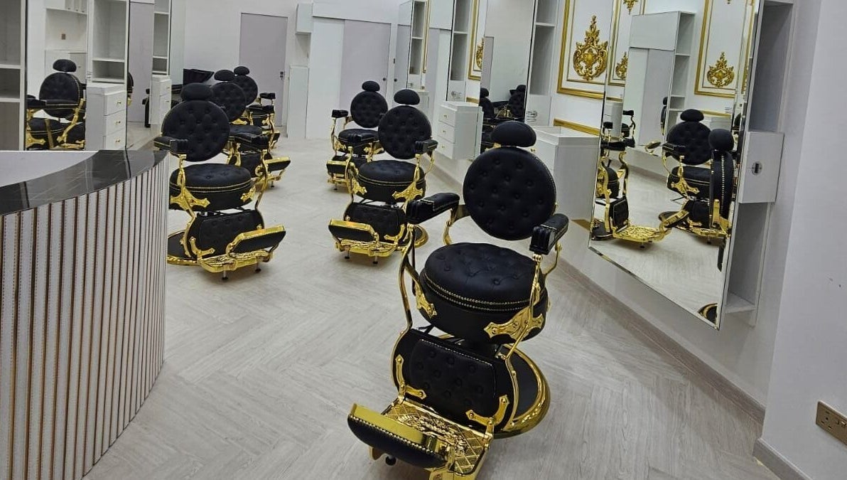 Elegant black and gold styling chairs at Dove Barbershop, Dubai, Dubai, AE, reflecting luxury and style.