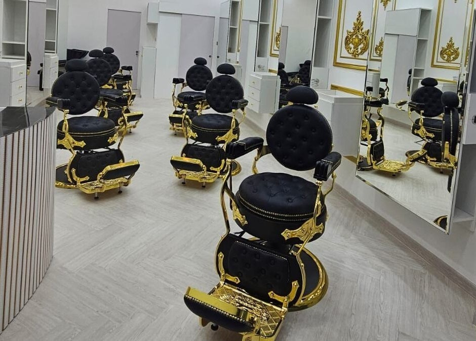Elegant black and gold styling chairs at Dove Barbershop, Dubai, Dubai, AE, reflecting luxury and style.