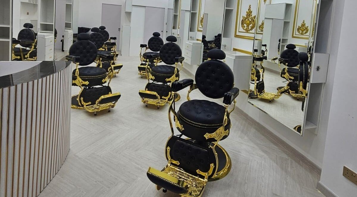 Elegant black and gold styling chairs at Dove Barbershop, Dubai, Dubai, AE, reflecting luxury and style.