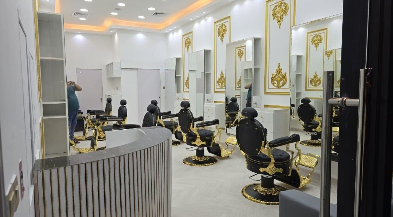 Luxurious interior of Dove Barbershop in Dubai, Dubai, AE featuring ornate chairs and gold accents.